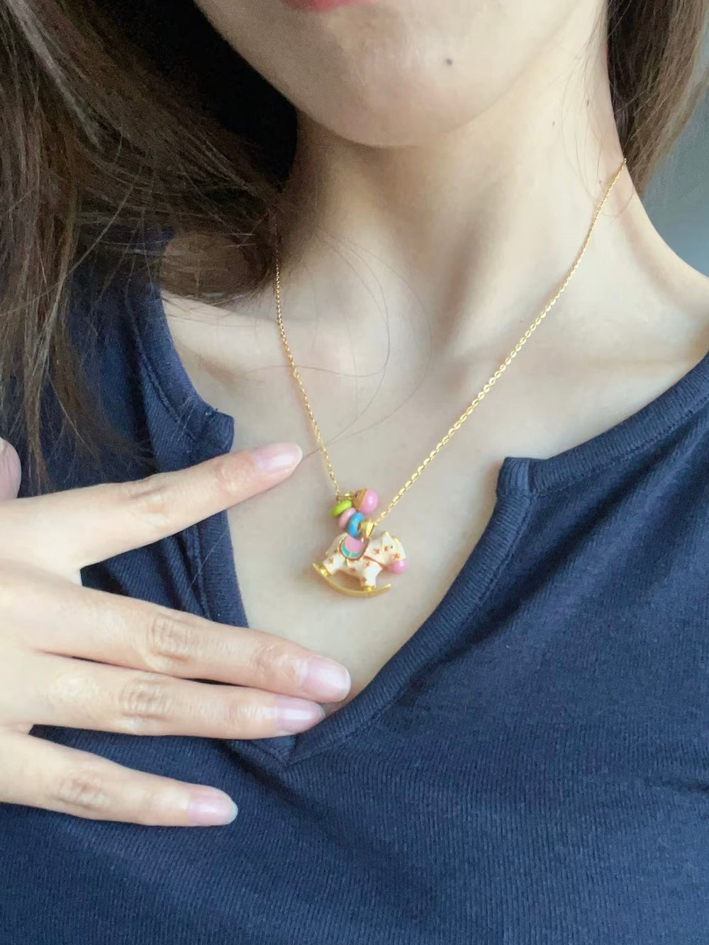 Enchanted Enamel Rocking Horse Charm Necklace with pastel rocking horse and miniature charms on a gold-plated chain.