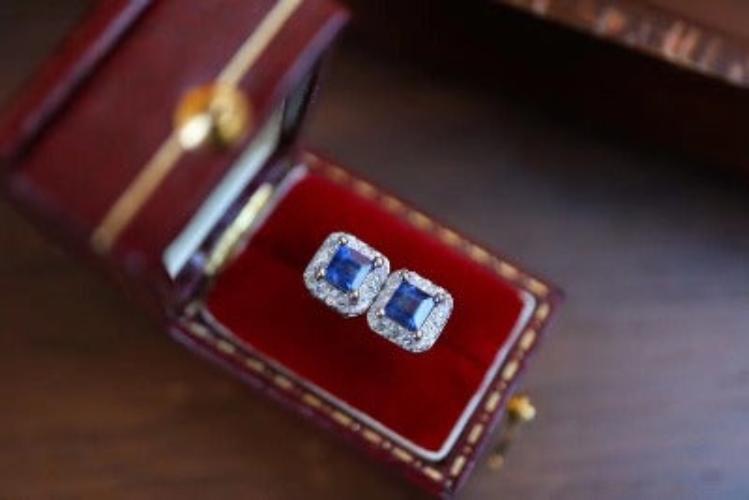 Vintage Sapphire Halo Stud Earrings featuring genuine blue sapphire stones surrounded by sparkling zirconia accents in a sterling silver setting.