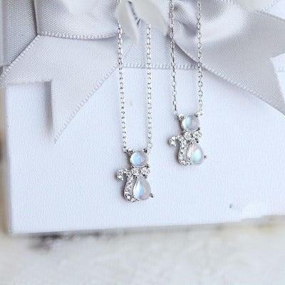 Enchanted Moonstone Cat Necklace featuring a luminous moonstone gemstone set within a cat-shaped pendant accented with sparkling details.