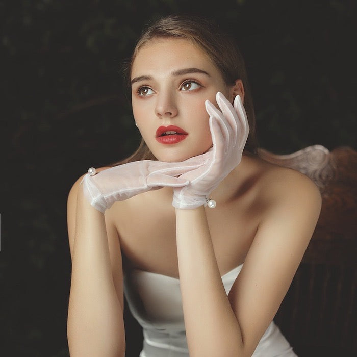 Couture Pearl & Lace Bridal Tulle Gloves crafted from soft sheer tulle, available with delicate pearl embellishments or embroidered lace cuffs for bridal wear.