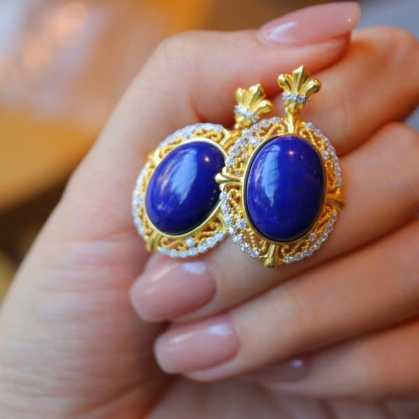 Renaissance Lapis Lazuli Statement Earrings featuring oval genuine lapis lazuli gemstones surrounded by sparkling accents and ornate gold vermeil detailing.