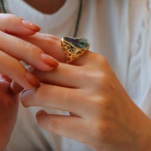 Ocean Wave Abalone Statement Ring featuring a genuine iridescent abalone shell set within a flowing gold vermeil wave-inspired adjustable ring design.