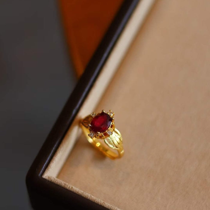 Natural Ruby Solitaire Statement Ring featuring a genuine red ruby gemstone with sparkling side accents in a sculpted gold-plated setting.