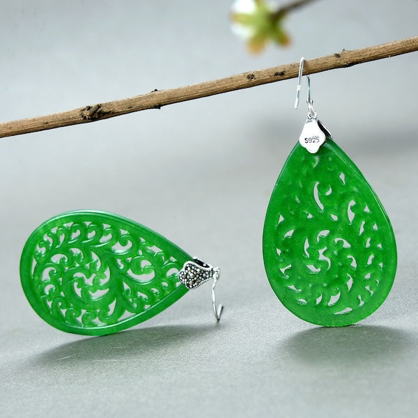 Ruyi Jade Waterdrop Earrings featuring vibrant green jade carved in an intricate openwork pattern within a large teardrop silhouette and sterling silver hooks.