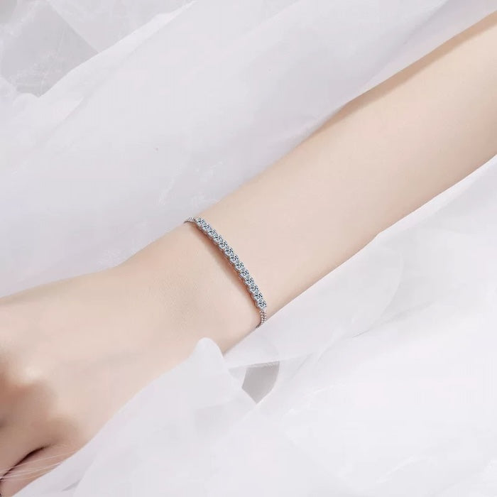 Chic Moissanite Smile Bracelet featuring thirteen sparkling 3 mm moissanite stones arranged in a delicate curved row on a sterling silver chain.