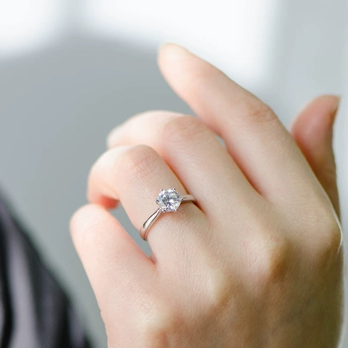 Timeless 6 Claw Solitaire Moissanite Ring featuring a round brilliant moissanite secured in a classic six-claw sterling silver setting.