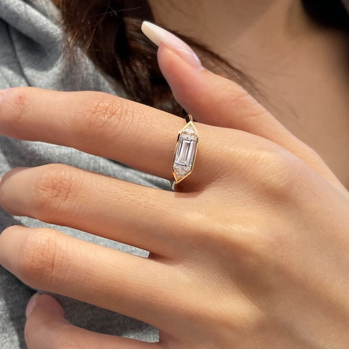 Radiant 3-Stone Moissanite Ring featuring a 1.4 ct emerald-cut center moissanite flanked by two side stones in an elegant gold vermeil setting.
