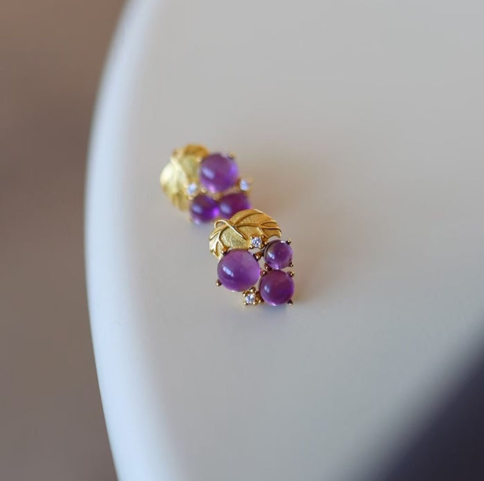 Delicate Amethyst Grape Ear Studs featuring genuine purple amethyst gemstones arranged in a grape cluster design with gold vermeil leaves and sparkling zirconia accents.