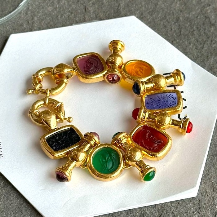 Imperial Cameo Charm Statement Bracelet featuring multicolored Roman-inspired cameo charms connected by an antiqued gold-tone chain.