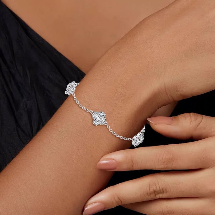 Eternal Clover Moissanite Bracelet crafted in sterling silver with five pavé-set four-leaf clover motifs adorned with brilliant moissanite stones and an adjustable chain.