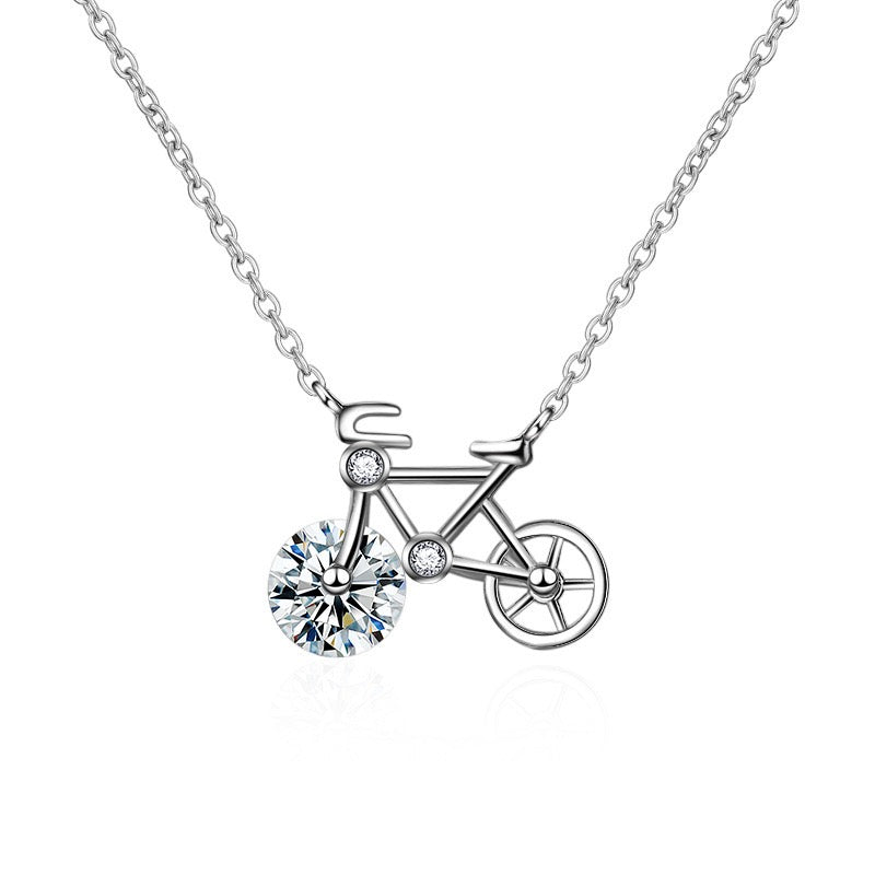 Moissanite Bicycle Necklace featuring a bicycle-shaped pendant with a sparkling 1 ct moissanite front wheel in a sterling silver setting.