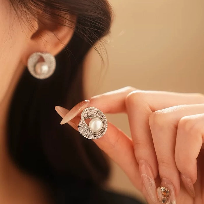 Radiant Pearl Halo Stud Earrings in silver-plated brass featuring a simulated pearl surrounded by a sparkling cubic zirconia halo.