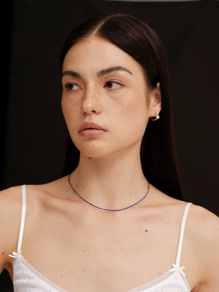 Lapis Lazuli Ultra Slim Necklace featuring delicate 1 mm genuine lapis lazuli beads in a minimalist royal-blue strand with gold-plated details.
