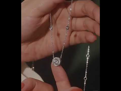 Star Halo Moissanite Necklace featuring a 1 ct round moissanite center stone surrounded by a sparkling halo, accented with bezel-set moissanite stones along a sterling silver chain.