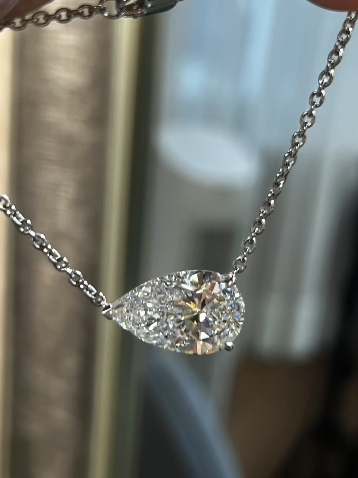 3CT pear cut moissanite solitaire necklace in 925 sterling silver with a delicate chain and minimalist setting.