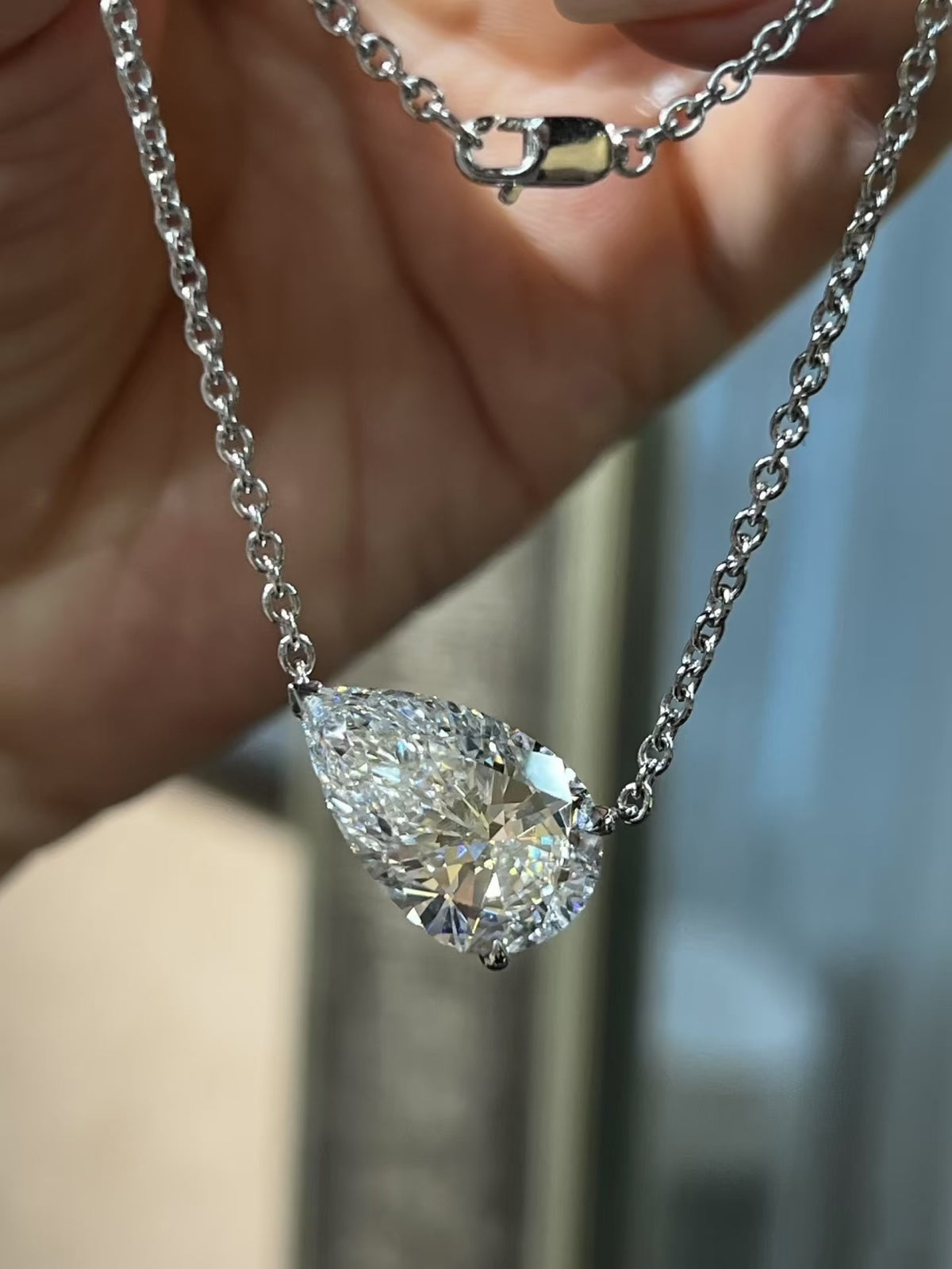 3CT pear cut moissanite solitaire necklace in 925 sterling silver with a delicate chain and minimalist setting.