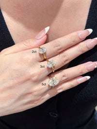 Éclat oval moissanite solitaire ring with VVS1 stone, four-prong setting and slender 14K gold-plated sterling silver band.