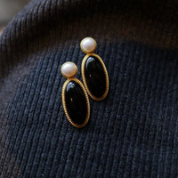 Heirloom black onyx pearl drop earrings crafted with genuine black onyx, freshwater pearls and gold vermeil.