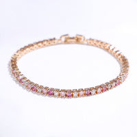 Dazzling Pink Ombré Tennis Bracelet featuring sparkling pink and clear zirconias in a gradient tennis bracelet design, available in two stone sizes.