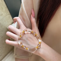 Moonlit Clear Quartz Crystal Bracelet featuring genuine moon-shaped clear quartz crystals, polished round quartz beads, and gold vermeil separation beads in a handcrafted floral-inspired design.