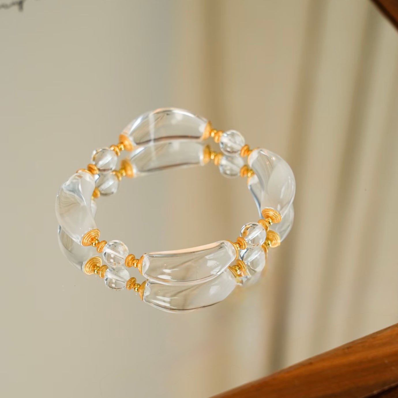 Moonlit Clear Quartz Crystal Bracelet featuring genuine moon-shaped clear quartz crystals, polished round quartz beads, and gold vermeil separation beads in a handcrafted floral-inspired design.