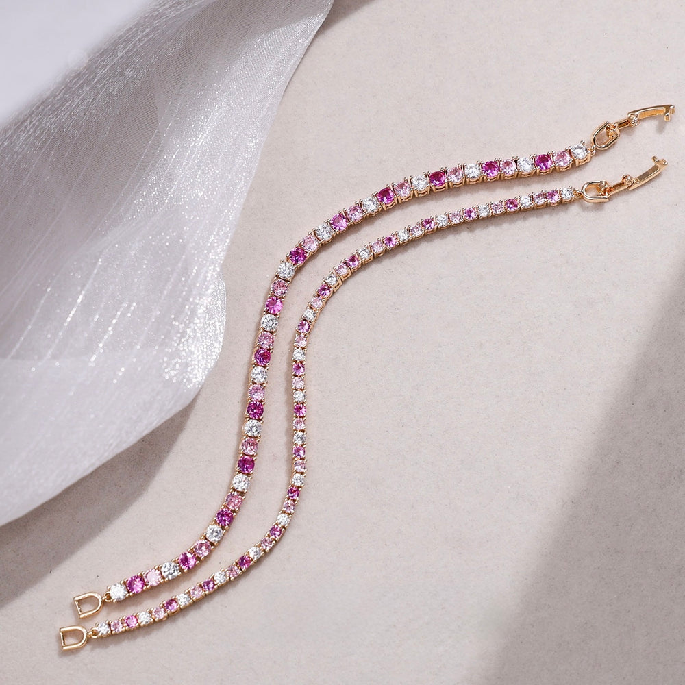 Dazzling Pink Ombré Tennis Bracelet featuring sparkling pink and clear zirconias in a gradient tennis bracelet design, available in two stone sizes.