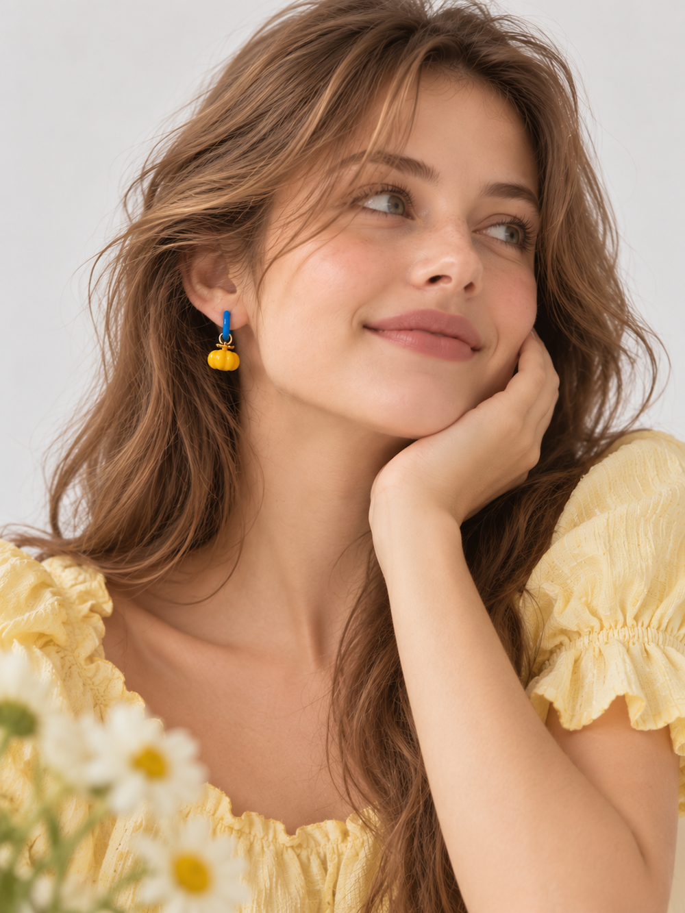 Enchanted Elephant & Pumpkin Enamel Hoop Earrings featuring a blue elephant charm and an orange pumpkin charm with vibrant hand-painted enamel on gold-plated brass hoops, measuring 3 × 1.5 cm.