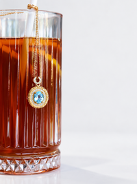 Heirloom Blue Topaz Pendant Necklace featuring an oval genuine blue topaz gemstone surrounded by ornate gold vermeil detailing and delicate sparkling accents.