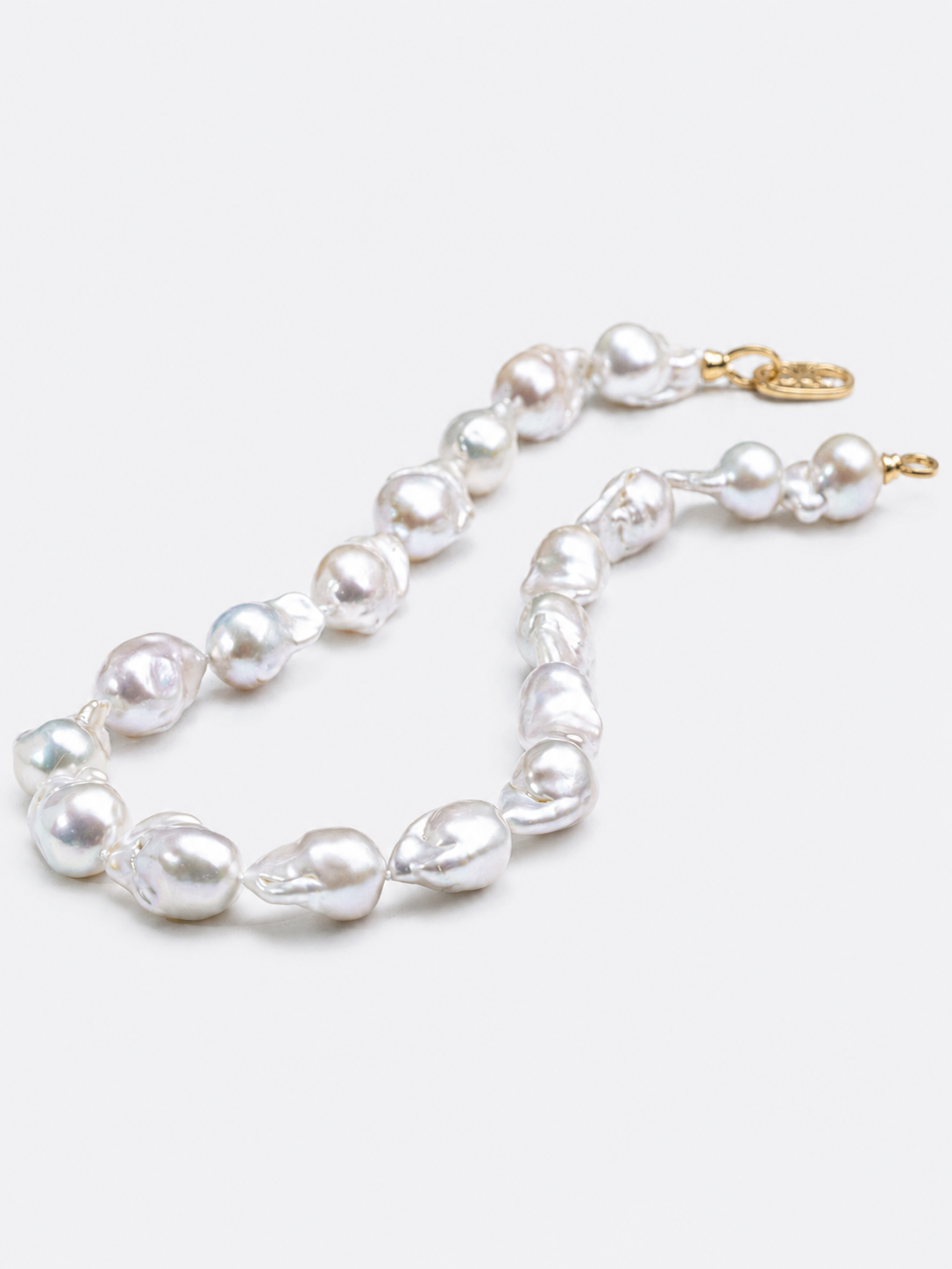 One-of-a-kind baroque pearl statement necklace featuring large irregular genuine freshwater pearls with naturally unique shapes and a gold vermeil closure.