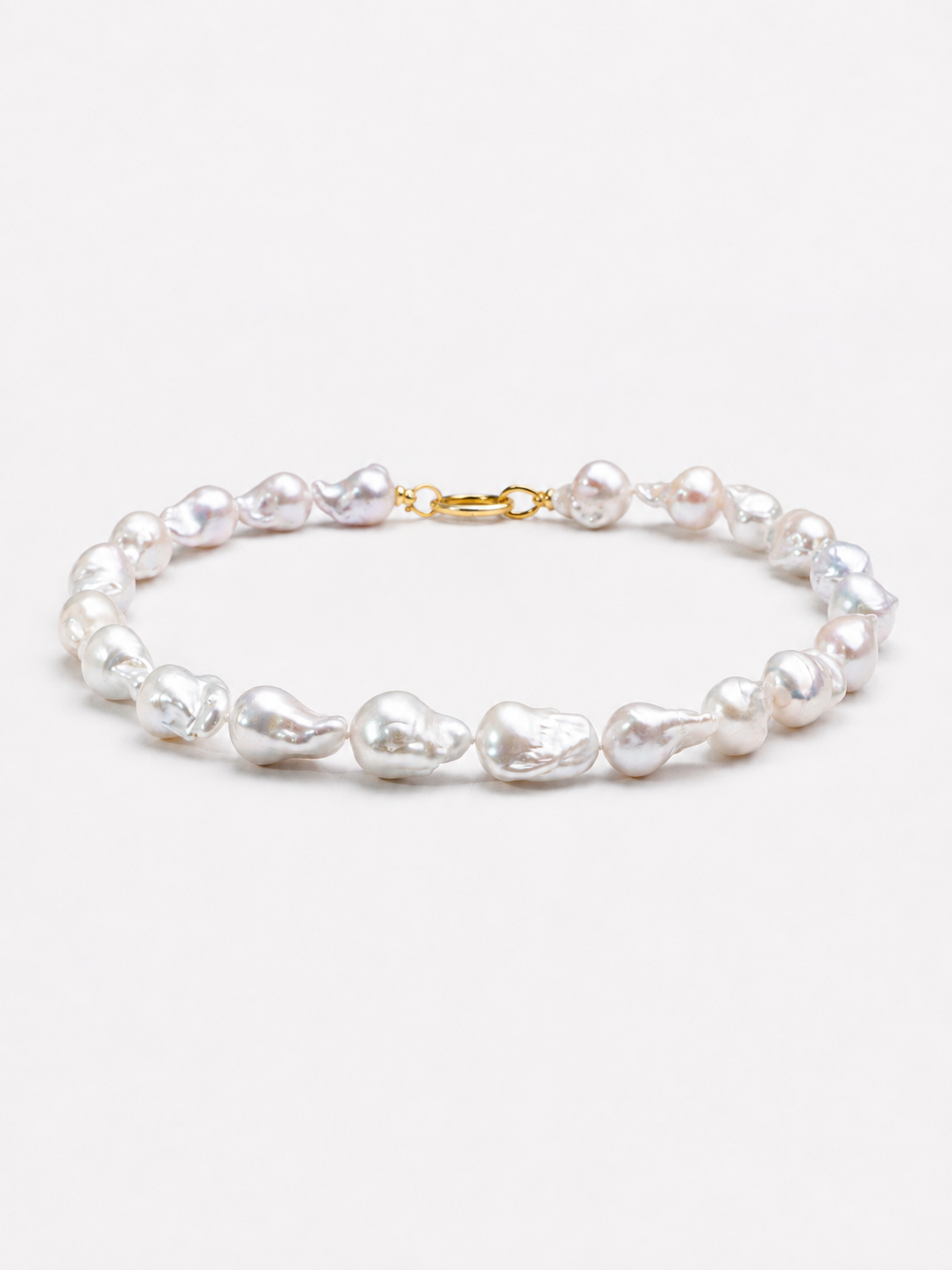 One-of-a-kind baroque pearl statement necklace featuring large irregular genuine freshwater pearls with naturally unique shapes and a gold vermeil closure.