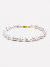 One-of-a-kind baroque pearl statement necklace featuring large irregular genuine freshwater pearls with naturally unique shapes and a gold vermeil closure.