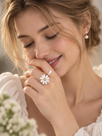 Luminous white daisy flower open ring with textured centre and delicate asymmetrical petal design.