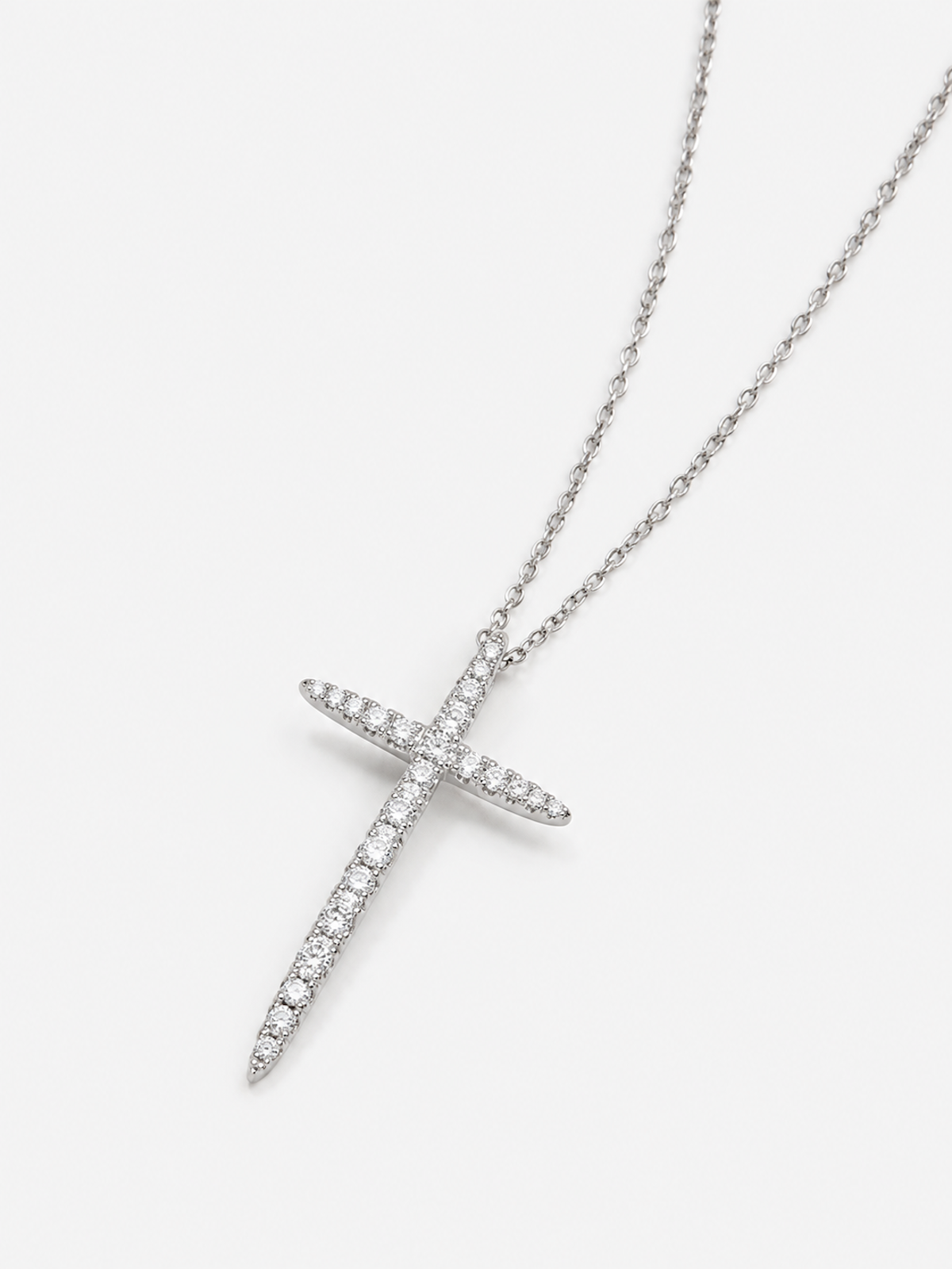 Refined tapered moissanite cross pendant necklace with elongated pointed design and delicate fine chain.