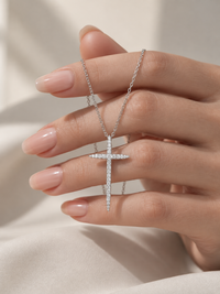Refined tapered moissanite cross pendant necklace with elongated pointed design and delicate fine chain.