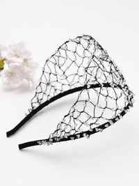 Wide black hairband with an intricate woven web design embellished with scattered clear crystal beads.