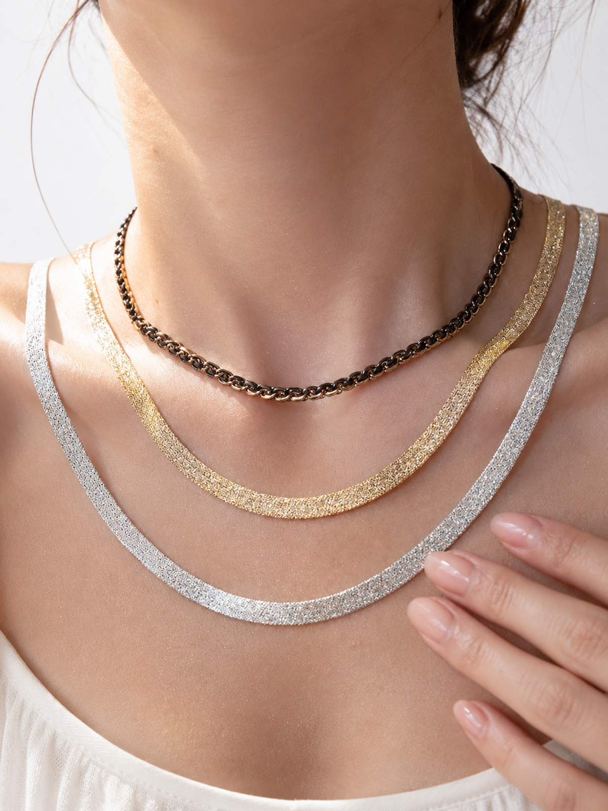 Ultra Shiny Layered Herringbone Chain Necklace featuring layered 7 mm herringbone chains with a highly polished finish in gold and silver-tone options.
