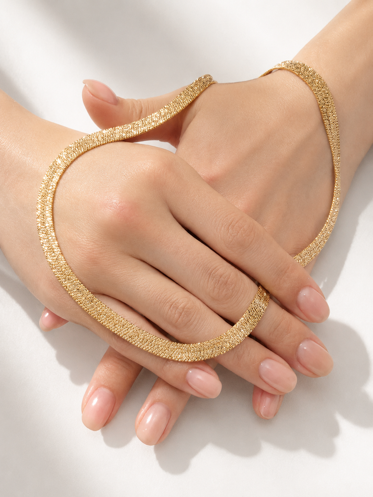 Ultra Shiny Layered Herringbone Chain Necklace featuring layered 7 mm herringbone chains with a highly polished finish in gold and silver-tone options.

