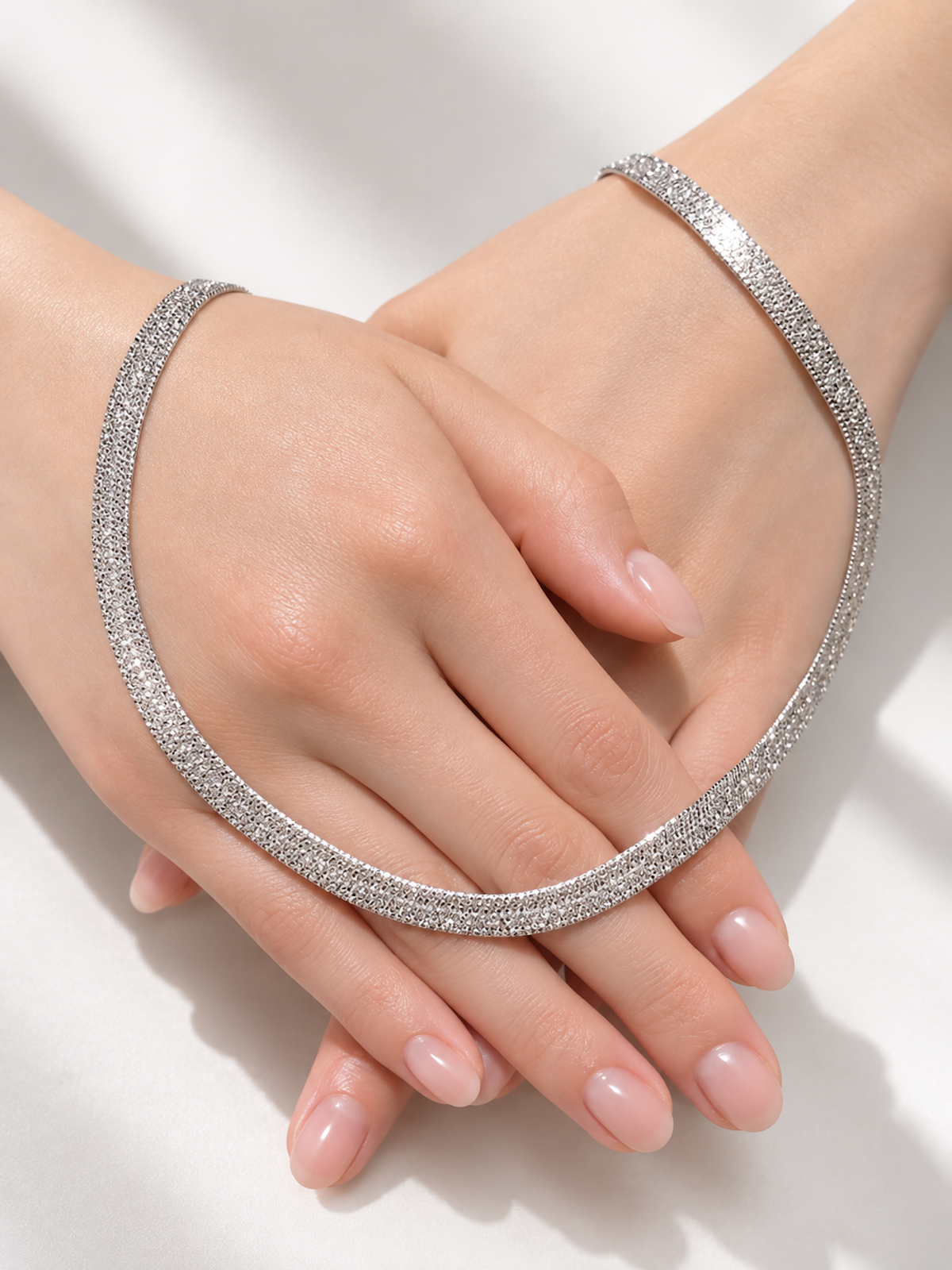 Ultra Shiny Layered Herringbone Chain Necklace featuring layered 7 mm herringbone chains with a highly polished finish in gold and silver-tone options.
