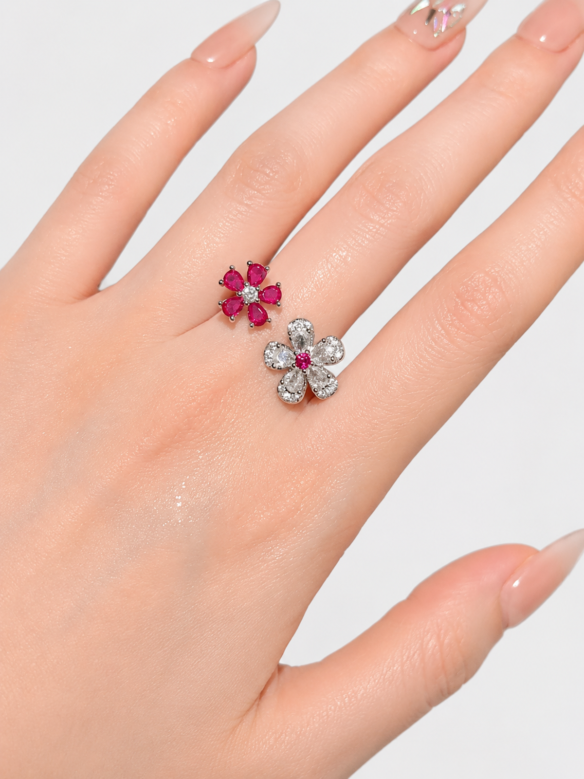 Ruby Plum Blossom Ring featuring ruby-colored and clear crystal plum blossoms on a white gold-plated adjustable band.