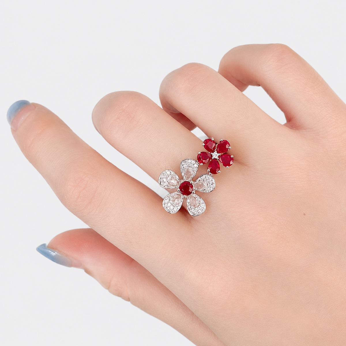 Ruby Plum Blossom Ring featuring ruby-colored and clear crystal plum blossoms on a white gold-plated adjustable band.