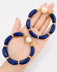 Imperial Lapis Lazuli Guardian Bracelet featuring genuine curved lapis lazuli beads, a hand-carved guardian bead, and gold vermeil accents in a handcrafted vintage-inspired design.
