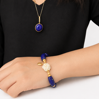 Imperial Lapis Lazuli Guardian Bracelet featuring genuine curved lapis lazuli beads, a hand-carved guardian bead, and gold vermeil accents in a handcrafted vintage-inspired design.
