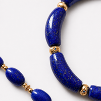 Imperial Lapis Lazuli Guardian Bracelet featuring genuine curved lapis lazuli beads, a hand-carved guardian bead, and gold vermeil accents in a handcrafted vintage-inspired design.

