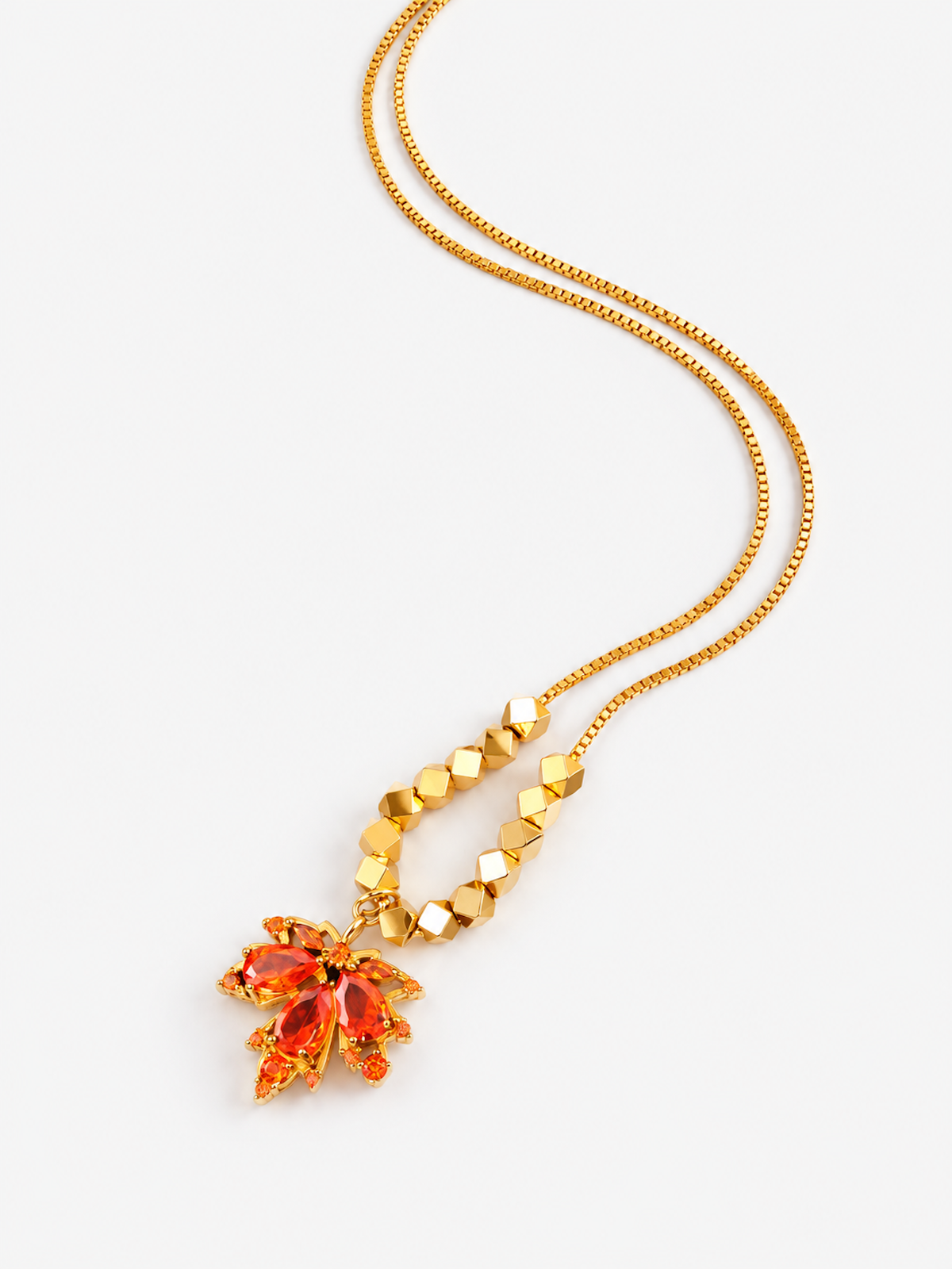 Fiery Orange Crystal Maple Leaf Necklace with orange crystal leaf pendant, faceted golden beads and delicate gold-plated chain.