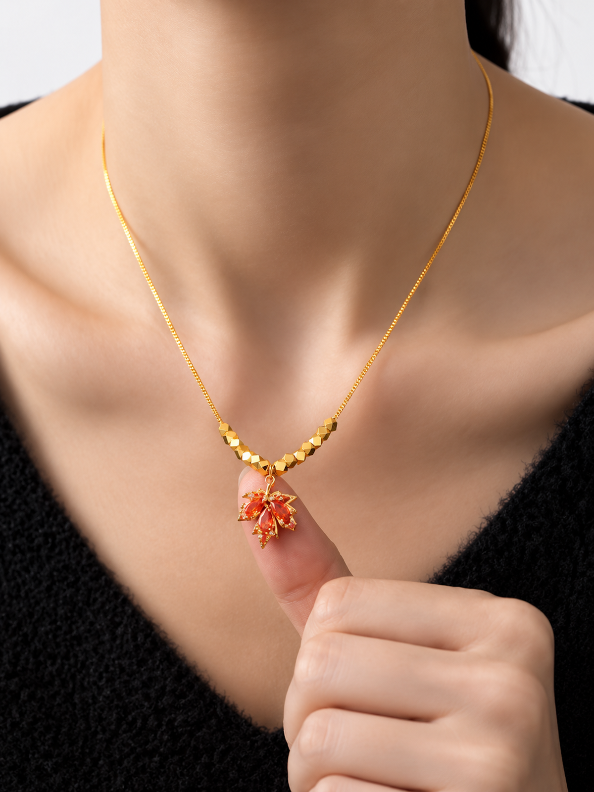 Fiery Orange Crystal Maple Leaf Necklace with orange crystal leaf pendant, faceted golden beads and delicate gold-plated chain.