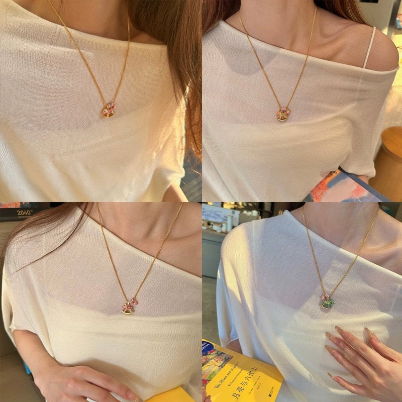 Enchanted Enamel Rocking Horse Charm Necklace with pastel rocking horse and miniature charms on a gold-plated chain.