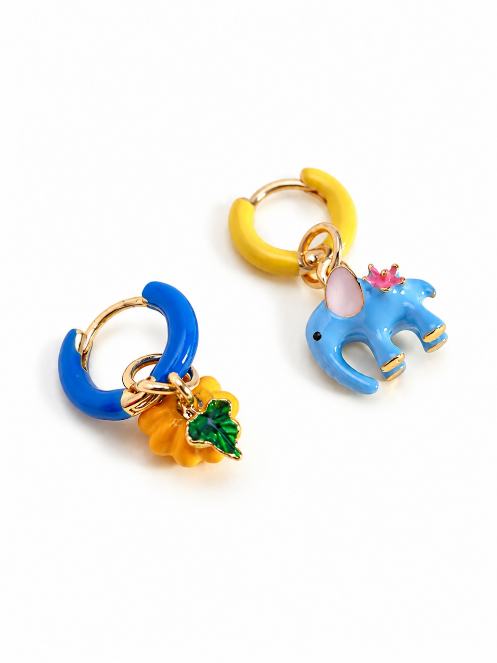 Enchanted Elephant & Pumpkin Enamel Hoop Earrings featuring a blue elephant charm and an orange pumpkin charm with vibrant hand-painted enamel on gold-plated brass hoops, measuring 3 × 1.5 cm.