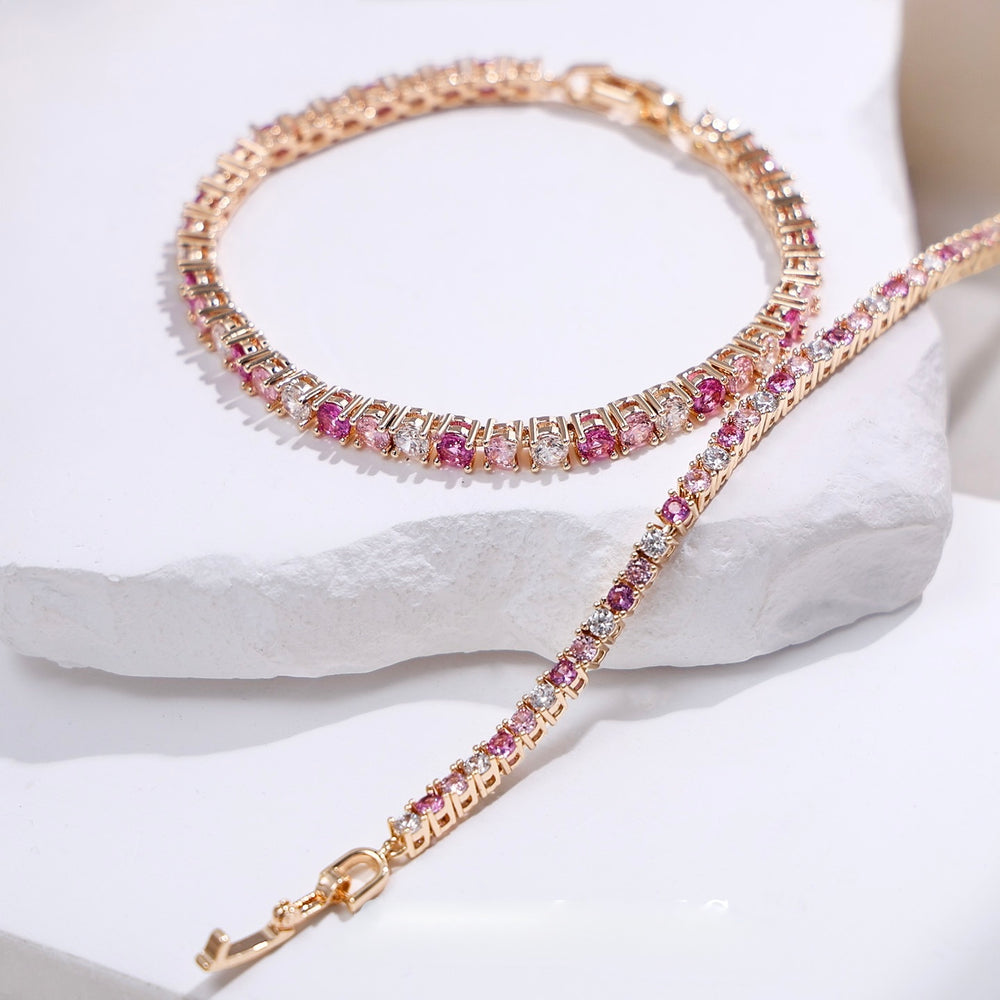Dazzling Pink Ombré Tennis Bracelet featuring sparkling pink and clear zirconias in a gradient tennis bracelet design, available in two stone sizes.
