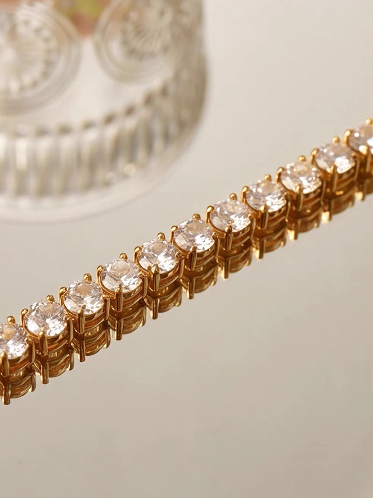   Timeless Diamond-Look Rivière Choker Necklace featuring a continuous row of brilliant diamond-look stones set in a gold-tone finish.
