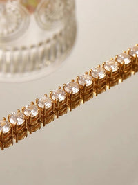   Timeless Diamond-Look Rivière Choker Necklace featuring a continuous row of brilliant diamond-look stones set in a gold-tone finish.
